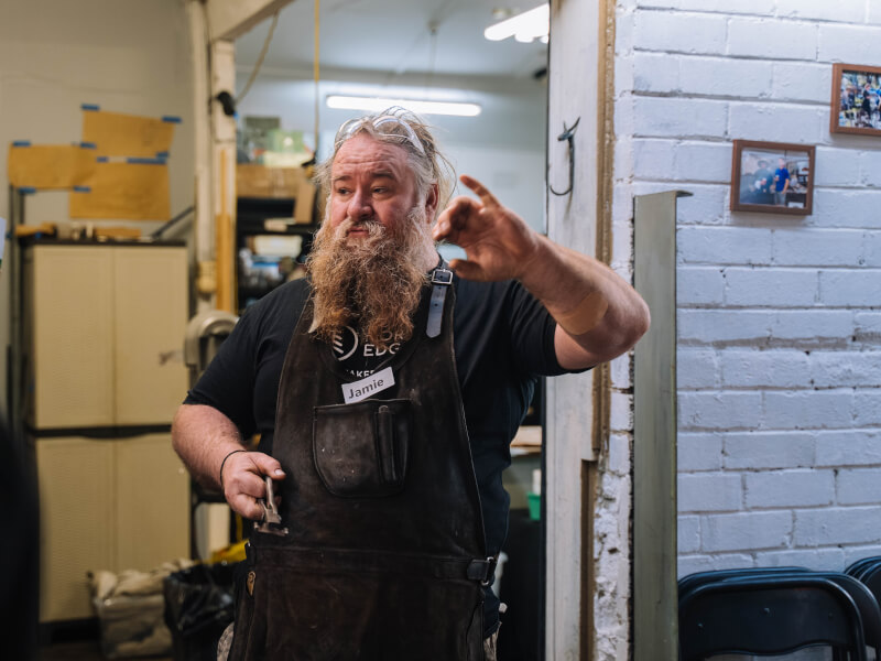Man wearing apron at a woodworking workshop in London